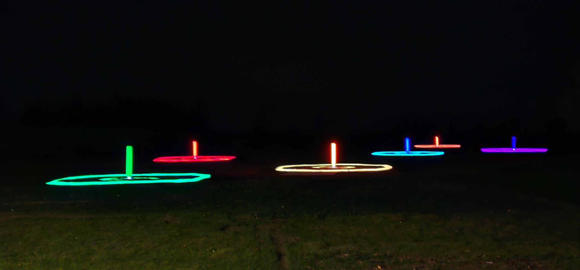 Glowing colored targets on the Flight Zone range at night