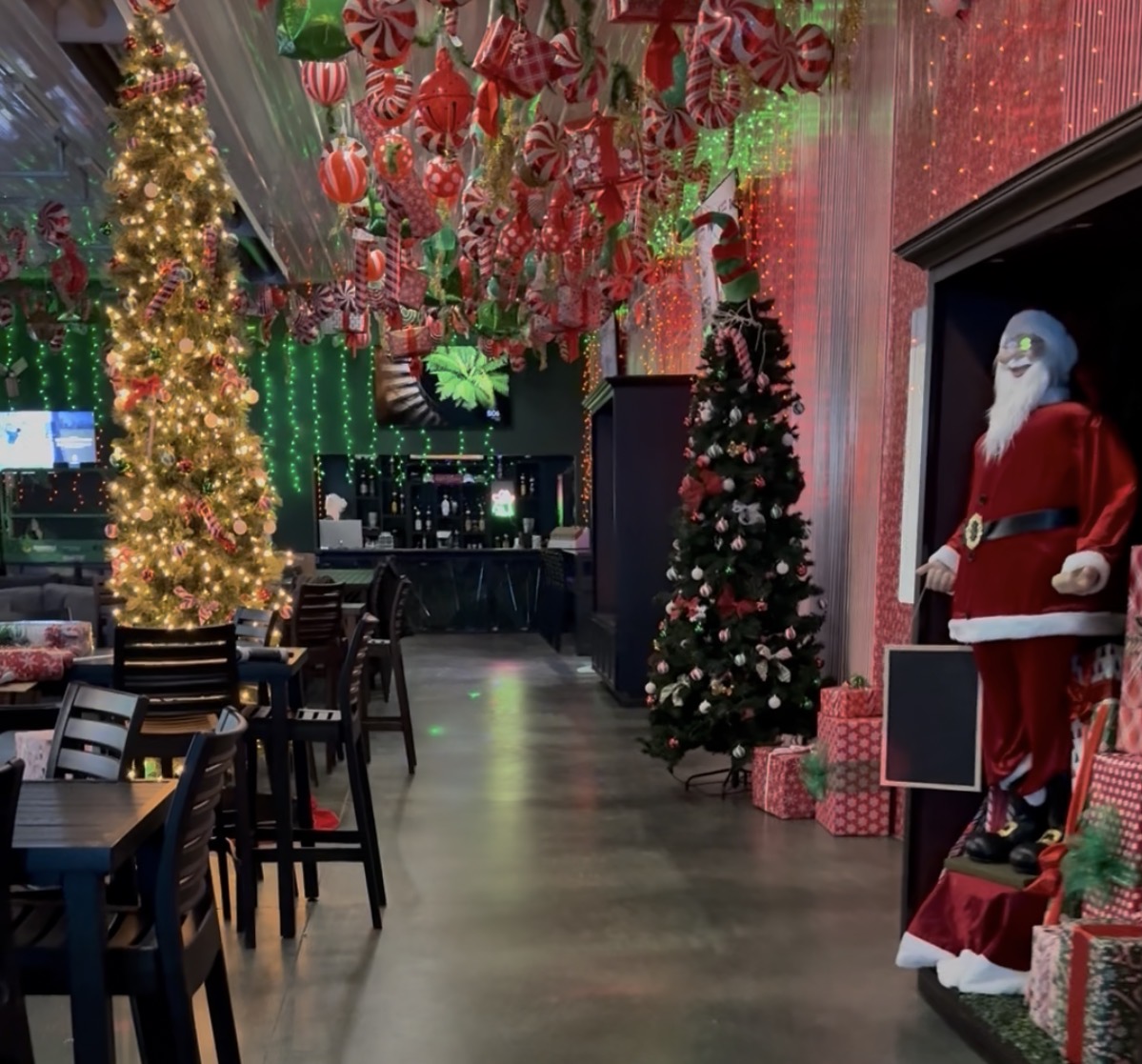 Lit Christmas trees and a life-size Santa in the decorated Flight Zone walkway